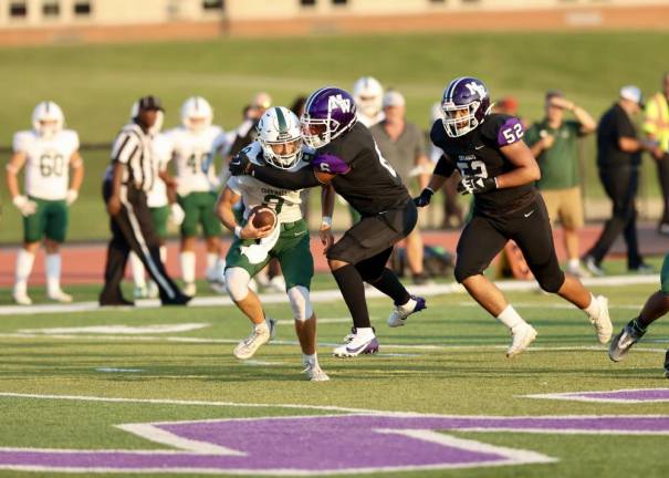 Julius Jeanty, #6, sacks the Dragon quarterback.