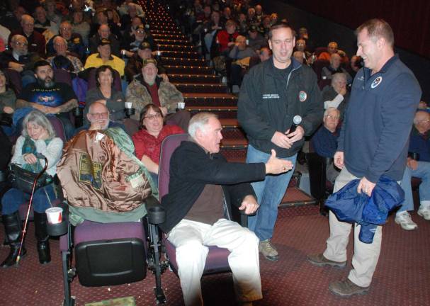 Photo by Ed Bailey Orange County hosted a free showing of the movie &#x201c;12 Strong&#x201d; at the Town of Monroe Arts and Civic Center on Jan. 24 for veterans. The demand was such that a second showing was added. Prior to the movie Orange County Deputy Commissioner of Emergency Services Alan C. Mack discussed his experience as a helicopter pilot during Operation Enduring Freedom in Afghanistan in 2001. He is pictured here with County Executive Steven M. Neuhaus, center, and veteran Rich White of Warwick.