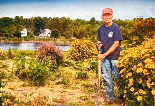 Jean Cramer working in a pollinator garden.