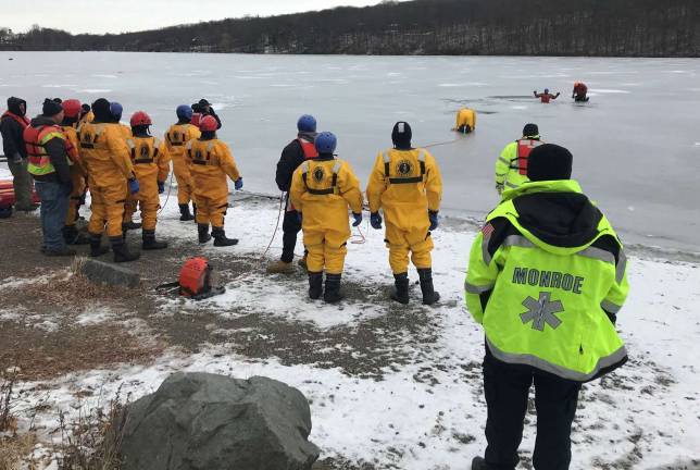 Photos by Wayne Jones On Sunday, Feb. 4, a Monroe Volunteer Ambulance duty crew was standing by while the Monroe Joint Fire District performed drills involving ice water rescue at Walton Lake.