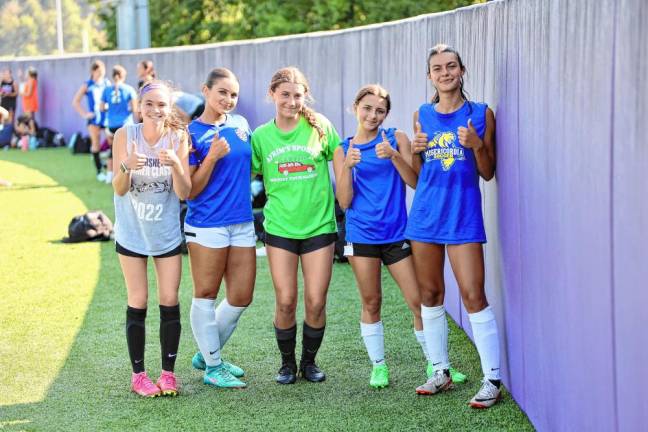 Players from the girls’ soccer team take a break during fitness drills.