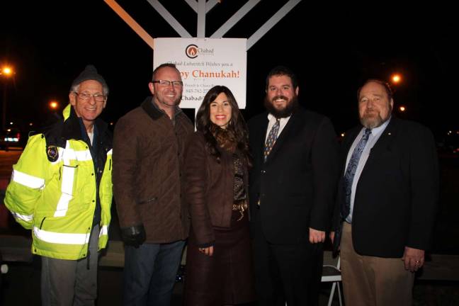 Pictures at a previous year&#x2019;s Monroe Menorah Lighting Ceremony: Firefighter Jeff Prager, Monroe Mayor Jim Purcell, Chana and Rabbi Pesach Burston of Chabad and Harriman Mayor Stephen Welle.