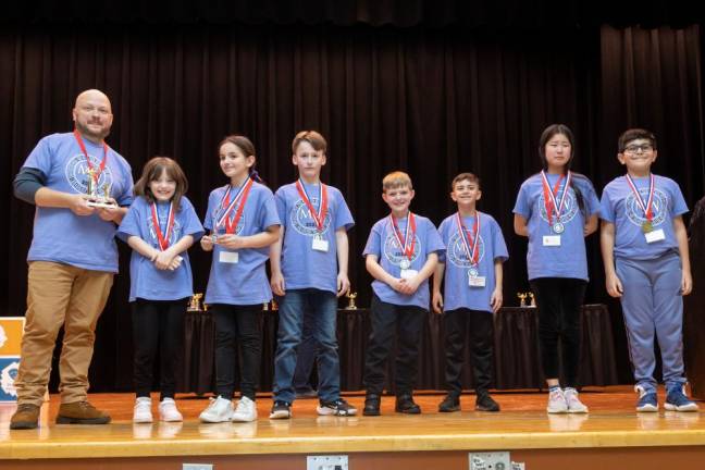 (L-R) Coach Peterson, Maeve Adler, Naomi Cao, Noah Austin, Aleksey Elisseenko, Laithuallah Haredy, Giulia Lepine, and Samir Malik won for Where’s the Structure.