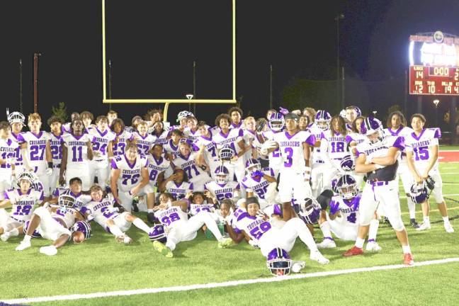 The Crusaders celebrate their opening day 21-14 victory.