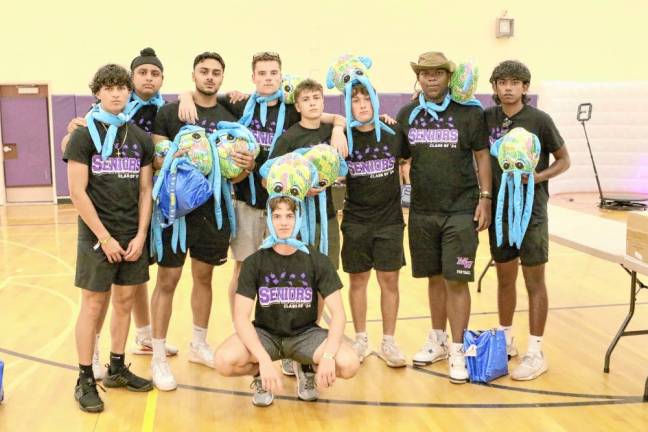 Seniors pose with their octopuses after the rain moved the event inside.