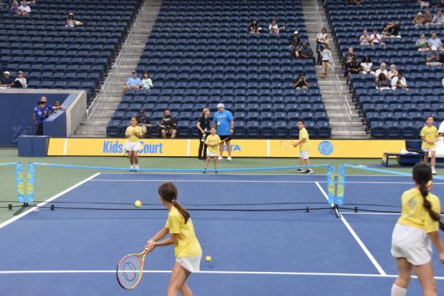 Kai Gara, of Matamoras, PA, hits a backhand during a youth tennis demo at the US Open. Twenty-four young players from Matchpoint Tennis in Goshen rallied for about seven minutes in Louis Armstrong Stadium in Queens before the evening match on Aug. 29.