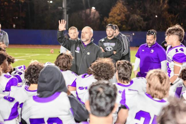 Head Coach James Sciarra addresses the Crusaders after their 16-12 victory.