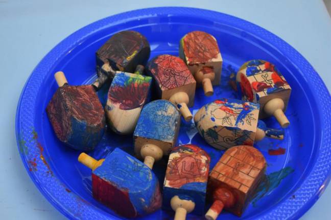 Dreidels painted by kids, drying.