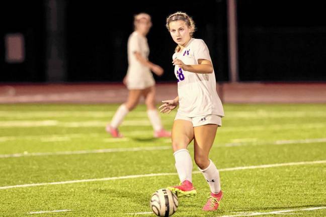 Elaina Wood, #18, passes the ball up the side line.