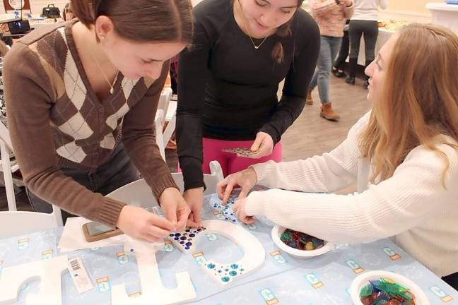 Teens work together to design décor for the new CTeen Lounge at Chabad of Orange County.