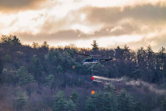 A helicopter brings water to the Jennings Creek Wildfire on Tuesday, Nov. 12.