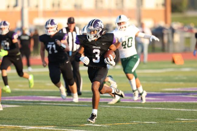 Louis Meade, #3, races 61 yards to put the Crusaders up 6-0 in the first quarter.