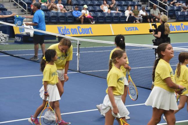 Coach Maeve Cassidy leads players off the court after the demo.