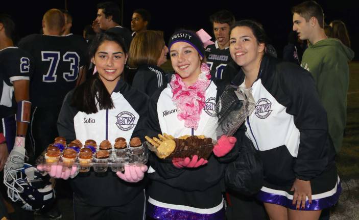 After the game, Sofia Pieczara, Allison Gardener and Maryann Nelson continue the Crusader tradition of bringing cookies and cupcakes to the team.