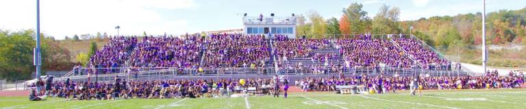 The Monroe-Woodbury student body fills the football stands and track.