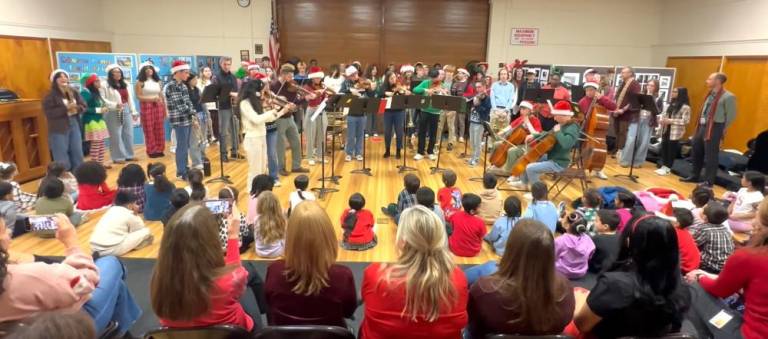 Students perform holiday songs.