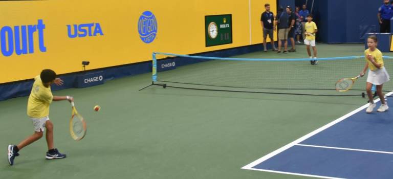 Twenty-four players from Matchpoint Tennis in Goshen took over the Louis Armstrong Stadium court before the evening match at the US Open on Aug. 29.