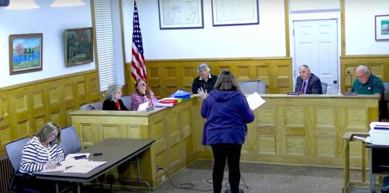 A resident shares her opinion about the village parking kiosks during the Oct. 15 Monroe Village Board of Trustees meeting.