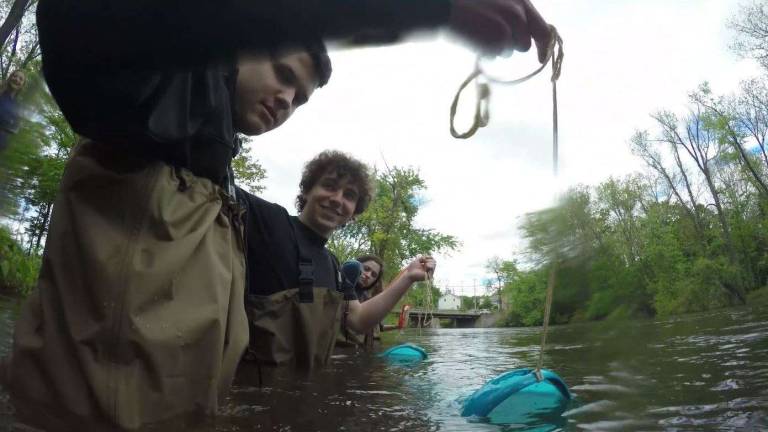 Students volunteering for the Beacon Institute netting microplastics in Fishkill Creek.