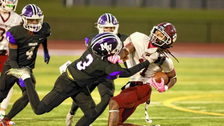 Crusader Louis Meade, #3, tackles a Tiger late in the game.