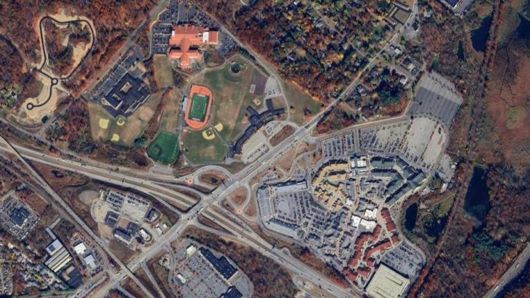 The Monroe-Woodbury school district (left) is directly across from Woodbury Common (right), separated by Route 32.