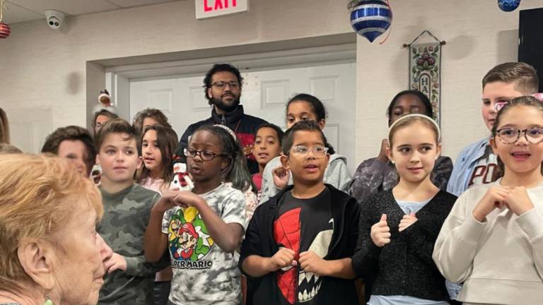 The students sang for the residents of the Promenade at Tuxedo Place.